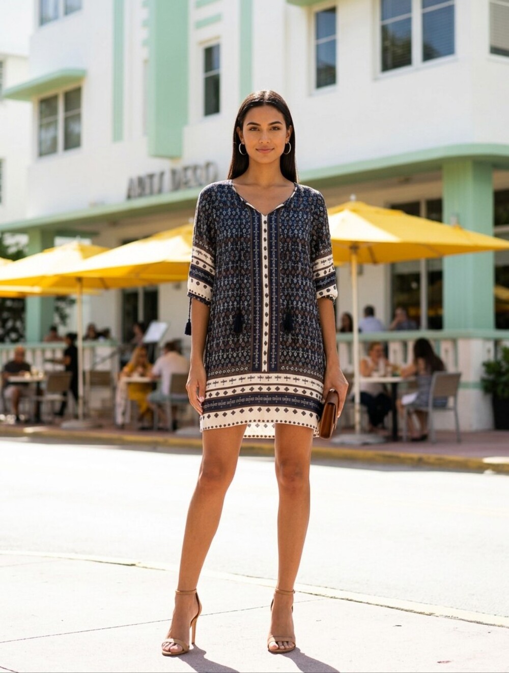 bohemian-style patterned tunic dress featuring a v-neckline and tassel details.
